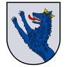 Ein blauer Wolf mit einer goldenen Krone auf dem Kopf steht auf zwei Beinen auf einem Schild. Der Wolf hat eine rote Zunge und schaut nach links.