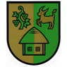 Das Wappen zeigt einen gespaltenen Schild. Die linke Hälfte ist braun mit einer Weinrebe und Trauben, die rechte Hälfte grün mit einem springenden Ziegenbock. In der Mitte steht ein Haus mit grünem Dach und braunen Wänden.