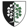 Ein schwarz-weißer Schild mit einem Baum, vertikal geteilt, hat links weiße Blätter und rechts grüne Blätter.