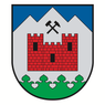 Ein Schild mit einer roten Burg und einem Hammer darüber, auf grünem und weißem Hintergrund.