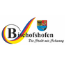 Das Logo von Bischofshofen, einer Stadt mit einem Wappen, das einen blauen und roten Schild mit einem Adler, einem Schwert und einem Löwen zeigt. Der Stadtslogan lautet 'Die Stadt mit Schwung'.