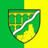 Ein grünes und gelbes Emblem zeigt eine Brücke mit Bogenöffnungen, eine Burg und eine wellenförmige Linie auf weißem Hintergrund.