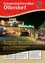 Titelseite eines deutschen Gemeindenewsletters mit einem Haus mit Weihnachtsbeleuchtung, die den Lesern ein frohes Weihnachtsfest und ein gesundes neues Jahr wünscht.