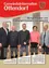 Postkartencover mit fünf Erwachsenen in Anzügen und Kleidern vor einer weißen Wand. Der Text lautet: 'Bürgermeister und Vizebürgermeisterin neu gewählt'.