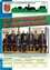 Ein Poster zeigt eine Gruppe von Männern in Anzügen und Krawatten, die auf Stühlen sitzen. Sie sind wahrscheinlich die Gemeinderäte von Ottendorf. Das Poster hat einen grünen Hintergrund mit den Worten 'Der neue Gemeinderat der Gemeinde Ottendorf'.
