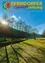 Die Titelseite einer Zeitschrift mit einer Landschaft, die ein grasbewachsenes Feld, Bäume und einen ruhigen See unter einem strahlenden Sonnenlicht zeigt. Der Titel lautet 'Er ist's!' mit begleitendem Text in Deutsch.