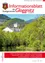 Eine friedliche Landschaft mit einem weißen Gebäude mit mehreren Schornsteinen, eingebettet zwischen üppigen grünen Bäumen und Bergen. Ein Fluss fließt im Vordergrund. Der Text 'der Stadtgemeinde Gloggnitz' und 'www.gloggnitz.at' ist oben angezeigt.