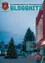 Das Cover der Gloggnitzer Zeitschrift zeigt einen geschmückten Weihnachtsbaum vor einem modernen Gebäude. Der Himmel ist bewölkt, und es gibt Straßenlaternen und Gebäude im Hintergrund.