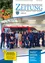 Eine Gruppe Feuerwehrleute steht vor einem roten Van mit der Aufschrift 122, mit einem jungen Mädchen und Jungen in der Mitte, in einer Garage.