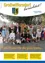 Eine Gruppe von Menschen, die in traditioneller Kleidung, einschließlich Dirndl und Lederhosen, gekleidet sind, posiert für ein Foto vor einem Baum. Der Text auf Deutsch lautet 'Eine Krone für die gute Ernte'. Das Bild hat einen Wasserzeichen mit dem Text 'Amtliche Mitteilung Ausgabe 3/2024'.