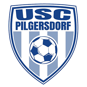 The emblem of USC Pilgersdorf features a shield with blue and white stripes, a soccer ball in the center, and the text 'USC PILGERSDORF' above the ball.