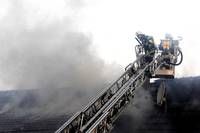 A fire truck ladder is positioned on a roof with thick smoke, suggesting an ongoing fire incident.