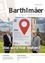 Zeitschriftencover mit zwei Männern neben einem Schild. Das Schild trägt 'Hier' mit einem roten Standort-Pin. Der Titel lautet 'Barthlmaer'. Das Cover hat einen QR-Code.