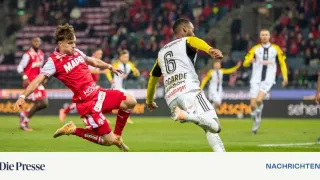 Two soccer players are on the field. One is wearing a red jersey and the other a white jersey with the number 6.
