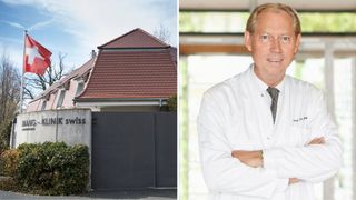 An image of a house with a red roof and a man standing in front of a window wearing a white coat and tie.