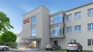 Eine architektonische Darstellung eines modernen Gesundheitszentrums mit zwei geparkten Autos davor. Das Gebäude trägt ein Schild mit der Aufschrift 'Gesundheitszentrum GHZ Bad Voslau'.