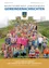 Ein Poster zeigt eine große Gruppe von Kindern, Erwachsenen und einem Spielplatz im Hintergrund. Es steht '50 Jahre Pfarrkindergarten Langenwang'.