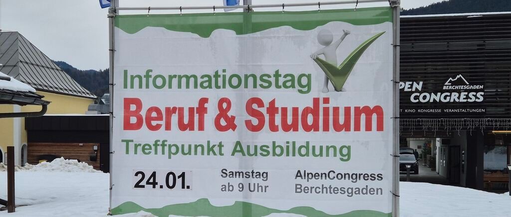 A signboard displays an event titled 'Informationstag Beruf & Studium'. It is scheduled for January 24th starting at 9 AM. The location is indicated as 'Treffpunkt Ausbildung'. The event is hosted by 'AlpenCongress Berchtesgaden'.