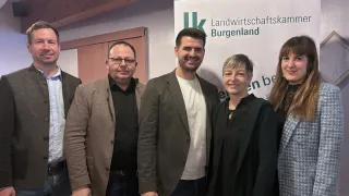 Five people are posing for a photo in front of a banner with the text Landwirtschaftskammer Burgenland.