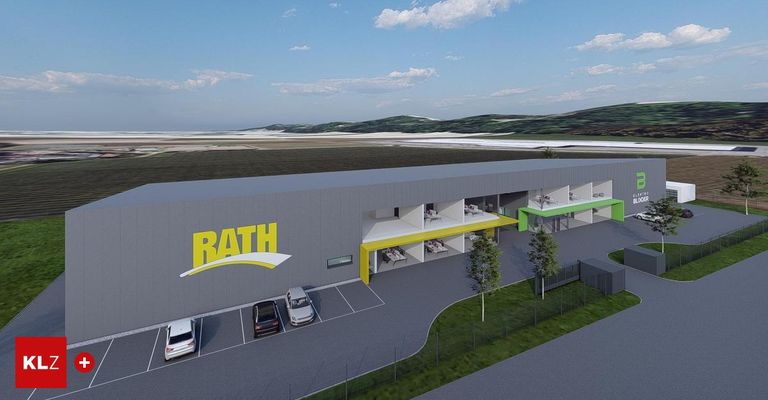 Eine architektonische Darstellung eines modernen Gebäudes mit dem Wort Bath in gelben Buchstaben. Das Gebäude hat einen großen Parkplatz mit drei geparkten Autos. Vor dem Gebäude befindet sich ein grün-gelber Vorbau. Vor dem Gebäude befinden sich auch Bäume und Gras.