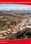 Luftaufnahme einer Stadt namens Marktgemeinde Wies entlang der Weißen Sulm mit vielen Häusern, Bäumen und einem blauen Himmel.