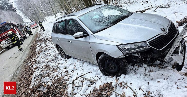 Ein silberner SUV ist auf einer verschneiten Straße verunglückt. Ein Feuerwehrmann inspiziert die Szene.