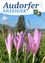 Die Titelseite zeigt eine lebendige Landschaft mit violetten Krokusblüten im Vordergrund und einem Baum und einer Bergkette im Hintergrund. Über den Blumen steht das Wort 'ANZEIGER' prominent.