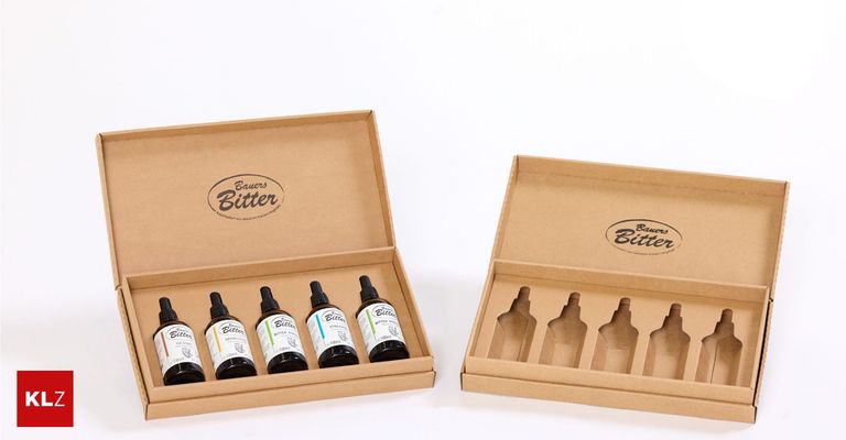 Two brown cardboard boxes filled with six bottles of Bauers Bitter, labeled with their names and ingredients. The boxes are open, displaying the bottles inside.