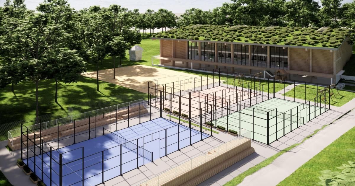 Eine Vogelperspektive auf einen modernen Sportkomplex mit mehreren Tennisplätzen, einem grün gedeckten Gebäude und einem üppigen grünen Park.