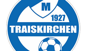The logo for FC M Traiskirchen features a blue shield with white borders. Inside the shield, there are the letters 'FC M' and the year '1927'. Below, the word 'TRAISKIRCHEN' is written in white on a blue background. A soccer ball is also depicted in blue and white.