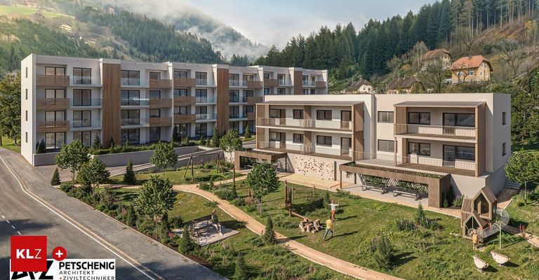 Ein Blick von oben auf ein modernes Apartmentgebäude mit einem Landschaftsgarten, mit Spielplatz, Bäumen und einem Weg. In der Ferne ein Berg mit Nebel.