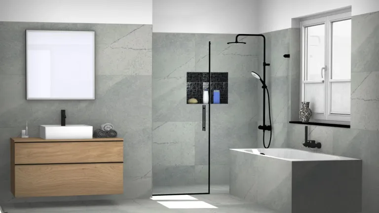 A modern bathroom features a gray tiled wall, a bathtub, and a glass shower door. A towel and a frame adorn the left side.