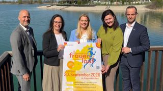 Four women stand by a lake holding a sign for the 13th Burgenland Frauenlauf on September 20, 2026 in Frauenkirchen, with various distances available for runners and walkers.