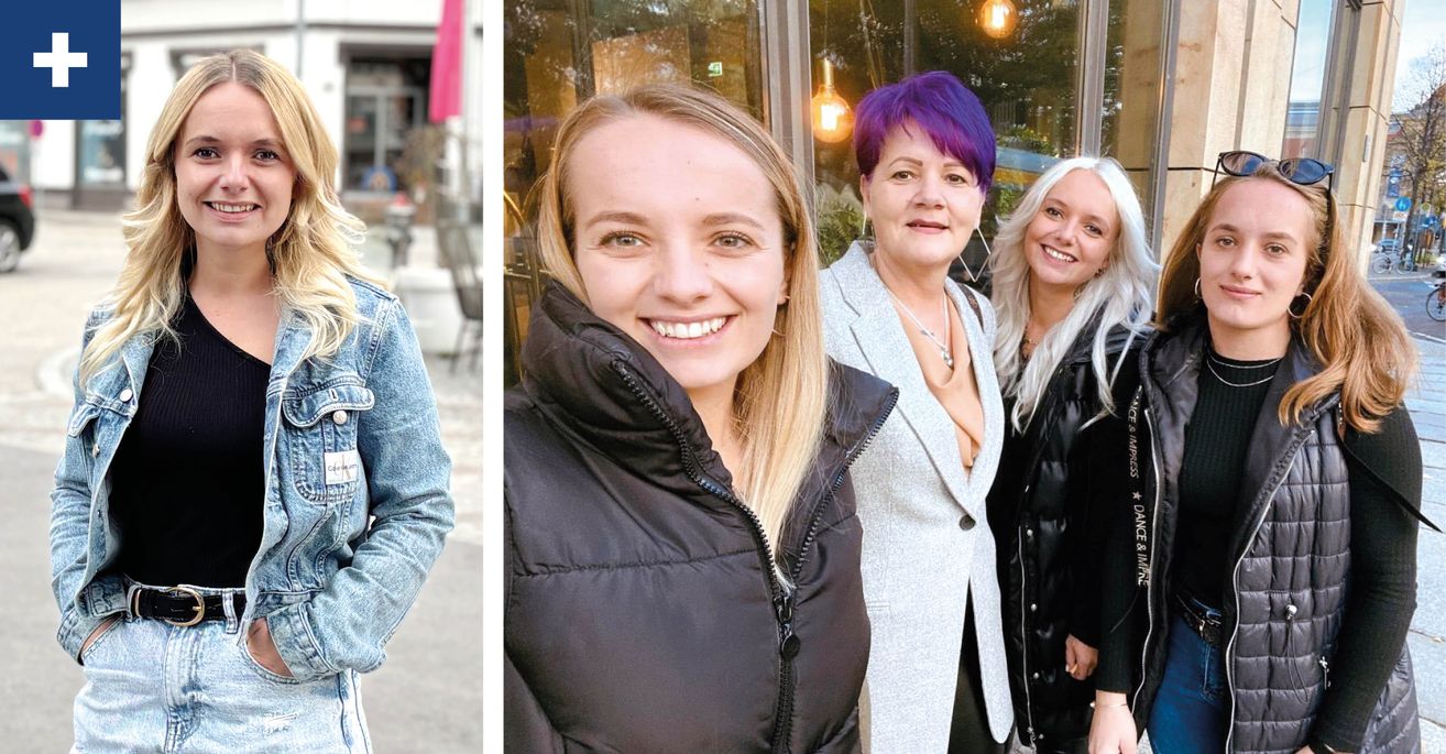 Drei Frauen stehen lächelnd nebeneinander. Die Frau in der Mitte hat blonde Haare und die Frau rechts hat lila Haare. Sie stehen vor einem Laden.