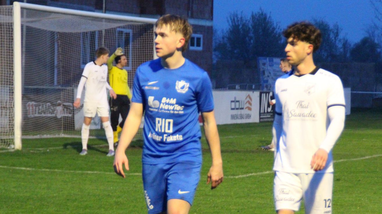 Soccer players in blue and white uniforms are on a field. One player in blue wears the name Rio on his jersey.