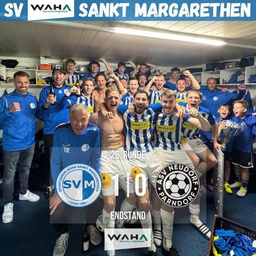 A soccer team in blue and white uniforms celebrates in the locker room. They are holding a trophy. The score is 11-0. The team is from Sankt Margarethen.