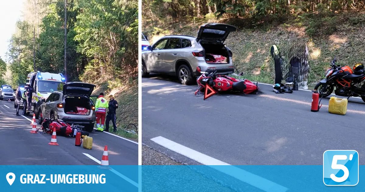 Rettungskräfte bei einem Motorradunfall. Ein rotes Motorrad liegt auf der Straße, mit einem Warndreieck und Kegel in der Nähe.