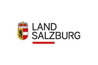 The logo for Land Salzburg, featuring a shield with a black eagle on a yellow background and the text 'Land Salzburg' in black letters.