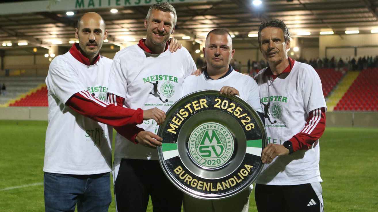 Four men in matching white shirts stand together holding a large trophy. The trophy features the text 'Meister 2025/26' and the logo of Burgenlandliga. The men are smiling.