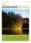 Ein Titelbild einer Zeitschrift mit einem friedlichen Wald und einem See, der sich auf dem Cover spiegelt. Der Titel 'GEMEINDEZEITUNG' ist oben angezeigt.