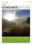 Das Cover einer Gemeindezeitung zeigt eine friedliche Landschaft mit einem sonnenbeschienenen Himmel und einem nebligen Feld. Der Titel steht in grüner Schrift und lautet 'GEMEINDEZEITUNG'.