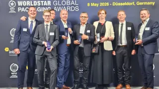 A group of people dressed formally stands behind a banner reading 'Worldstar Global Packaging Awards'. They are smiling and holding awards. The event took place on May 8, 2026, in Düsseldorf, Germany.