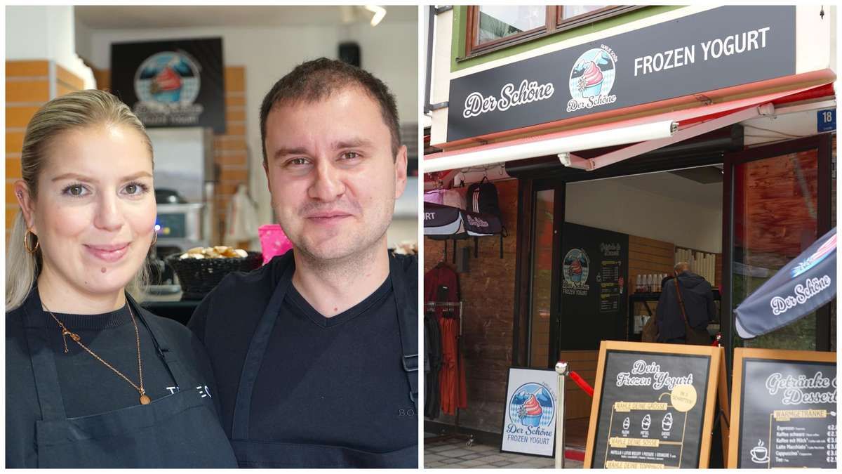 Zwei Männer in Schürzen stehen neben einem Geschäft mit einem Schild 'Der Schone Frozen Yogurt'. Im Inneren sind Artikel ausgestellt, und ein Kreidetafel-Menü ist sichtbar.