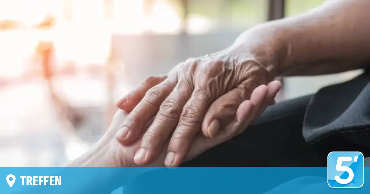 Two elderly hands holding each other closely, one wrinkled and the other smooth, showcasing the warmth of human connection.