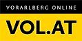 A yellow and black sign with white text that reads 'Vorarlberg Online' at the top and 'VOL.AT' below it in large black letters.