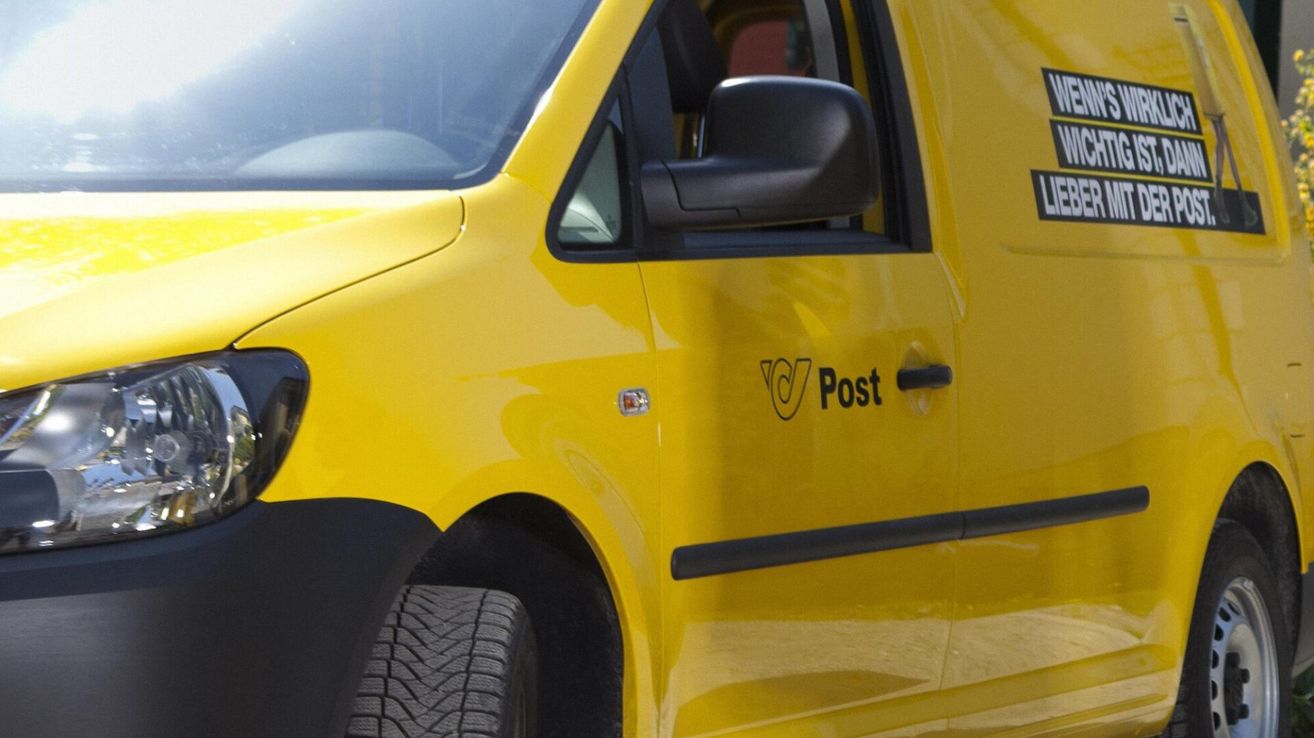 A close-up view of a yellow postal vehicle. The word 'Post' is printed on the side door.
