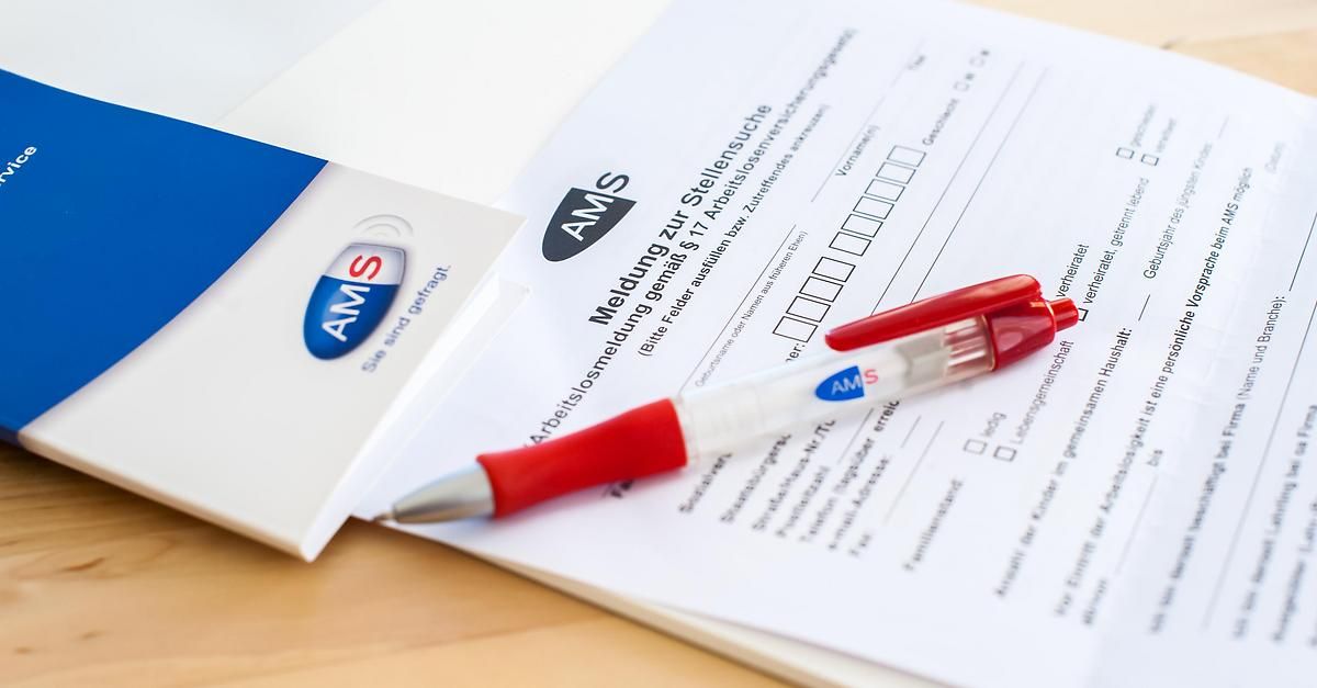 Ein roter und weißer Stift liegt auf einem Formular mit der Aufschrift 'Meldung zur Stellensuche' mit einem blau-weißen Logo. Das Formular befindet sich auf einem weißen Umschlag mit demselben Logo.