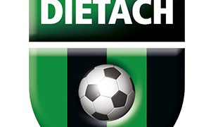 Ein Fußballemblem mit dem Text 'Union Procon Dietach' über einem Fußball und dem Jahr '1973' darunter, auf einem grün-schwarz gestreiften Hintergrund.