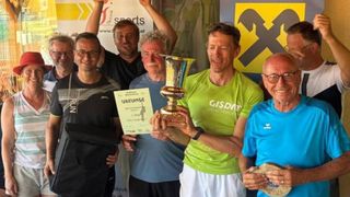 A group of men are posing for a photo with a trophy and certificates. They are smiling and appear to be celebrating a victory. The man in the middle is holding a trophy, and the man on the right is holding a certificate. Behind them is a banner with the text 'sports' and a logo.