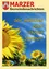 Ein Poster mit Sonnenblumen und blauem Himmel, der Text lautet 'Wir wünschen einen schönen Sommer!' auf Deutsch.